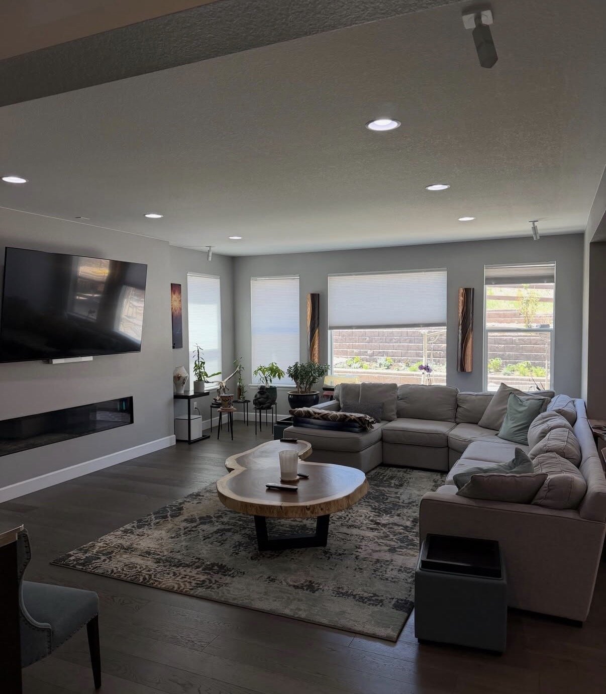 Modern Tampa living room with sectional sofa, fireplace, and spotless finishes — cleaned by Iconiq Cleaning Services